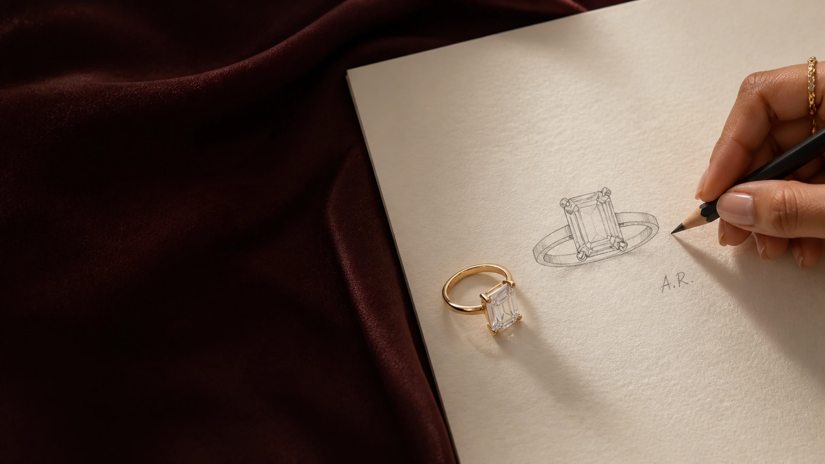An emerald-cut ring beside its personalised graphite design sketch